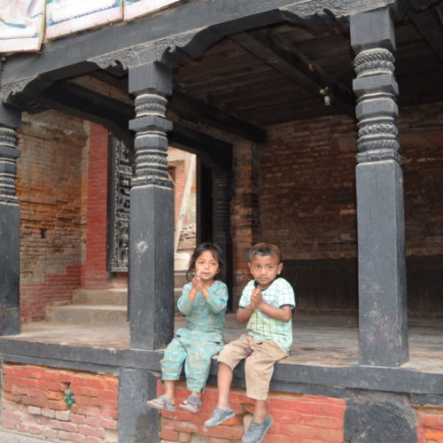 Boy and girl greeting tourists in Bhaktapur