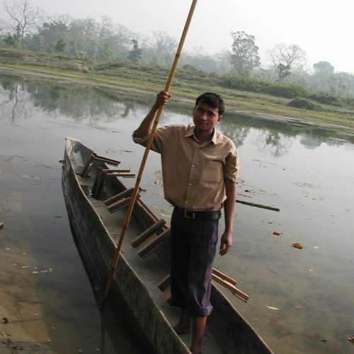 Boat driver with his boat at Rapti river, Chitwan